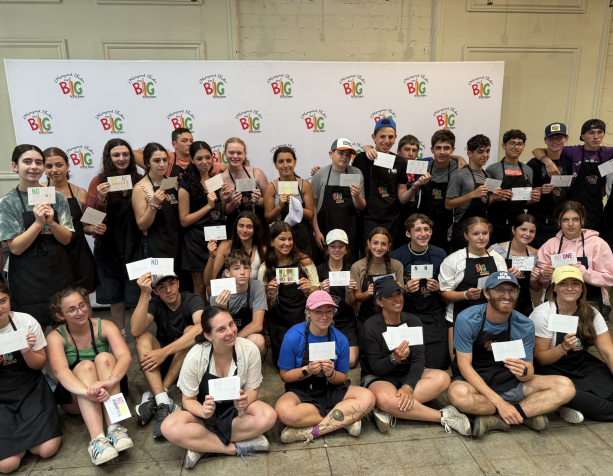 Students with postcards in a group photo